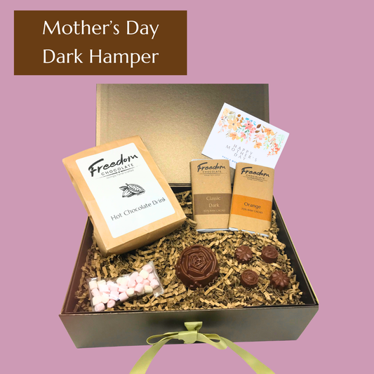 Dark Mother’s Day chocolate hamper featuring Classic Dark and Dark Orange artisan bars, hot chocolate, mallows and solid chocolate flowers in a gorgeous hamper.